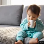 소아 인후염 증상과 예방 방법 - A tender scene showing a young child, around 3 years old, wearing a cozy long-sleeve pajama set and ...